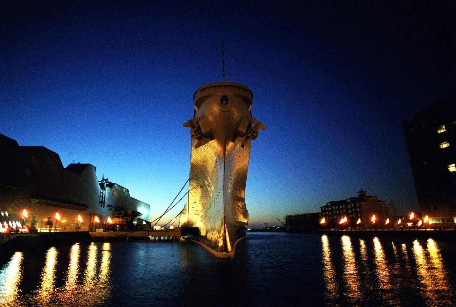 The battleship USS Wisconsin lit up at night beside Nauticus on the downtown Norfolk waterfront, the setting for Winterfest on the Wisconsin.