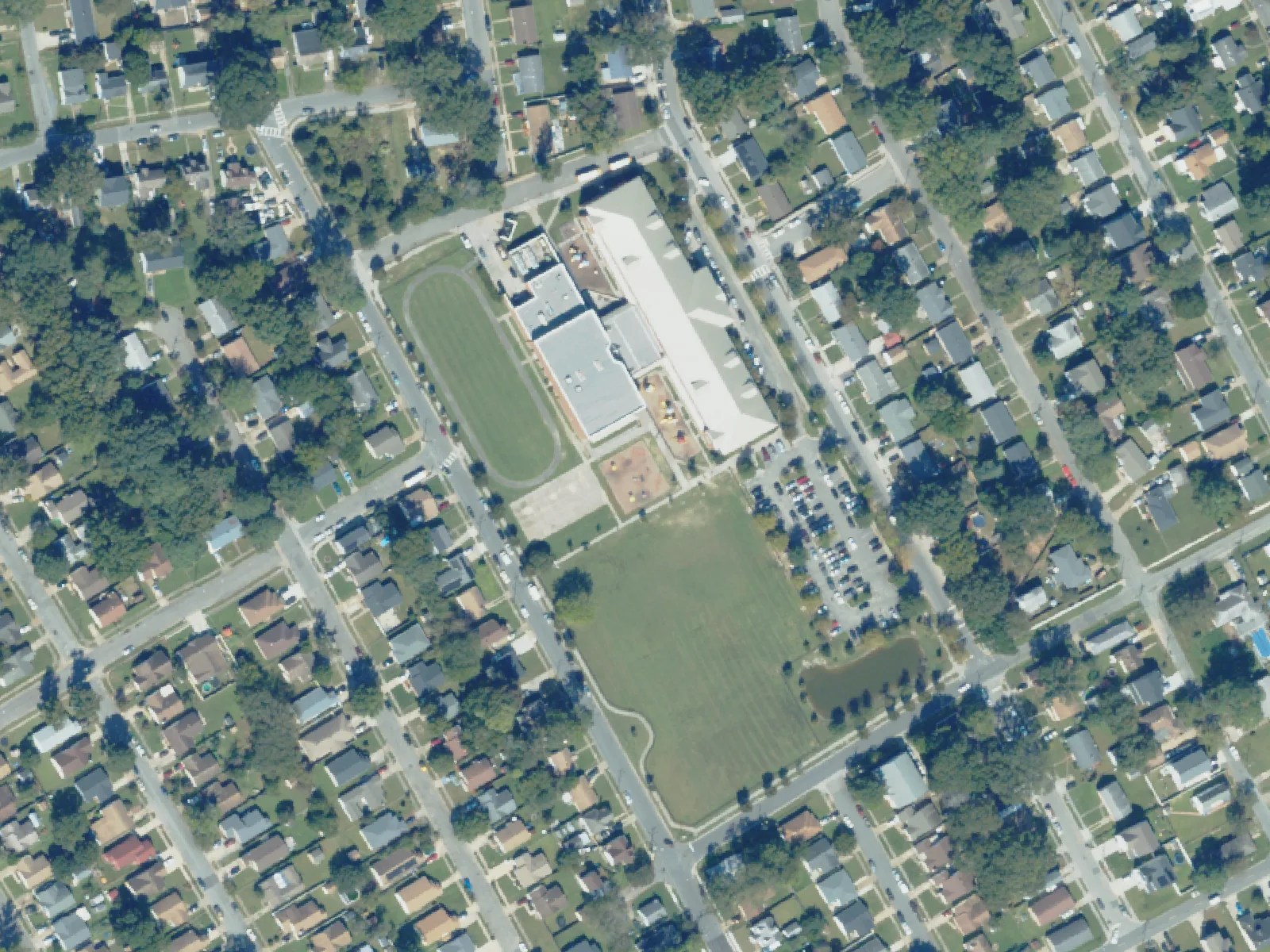 Coleman Place Elementary School and its grounds, center, from the air in October 2023.