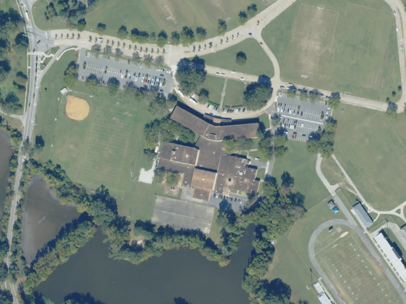 Lake Taylor School, center, beside a pond on Kempsville Road, with Lake Taylor High's stadium at lower right, from the air in October 2023.