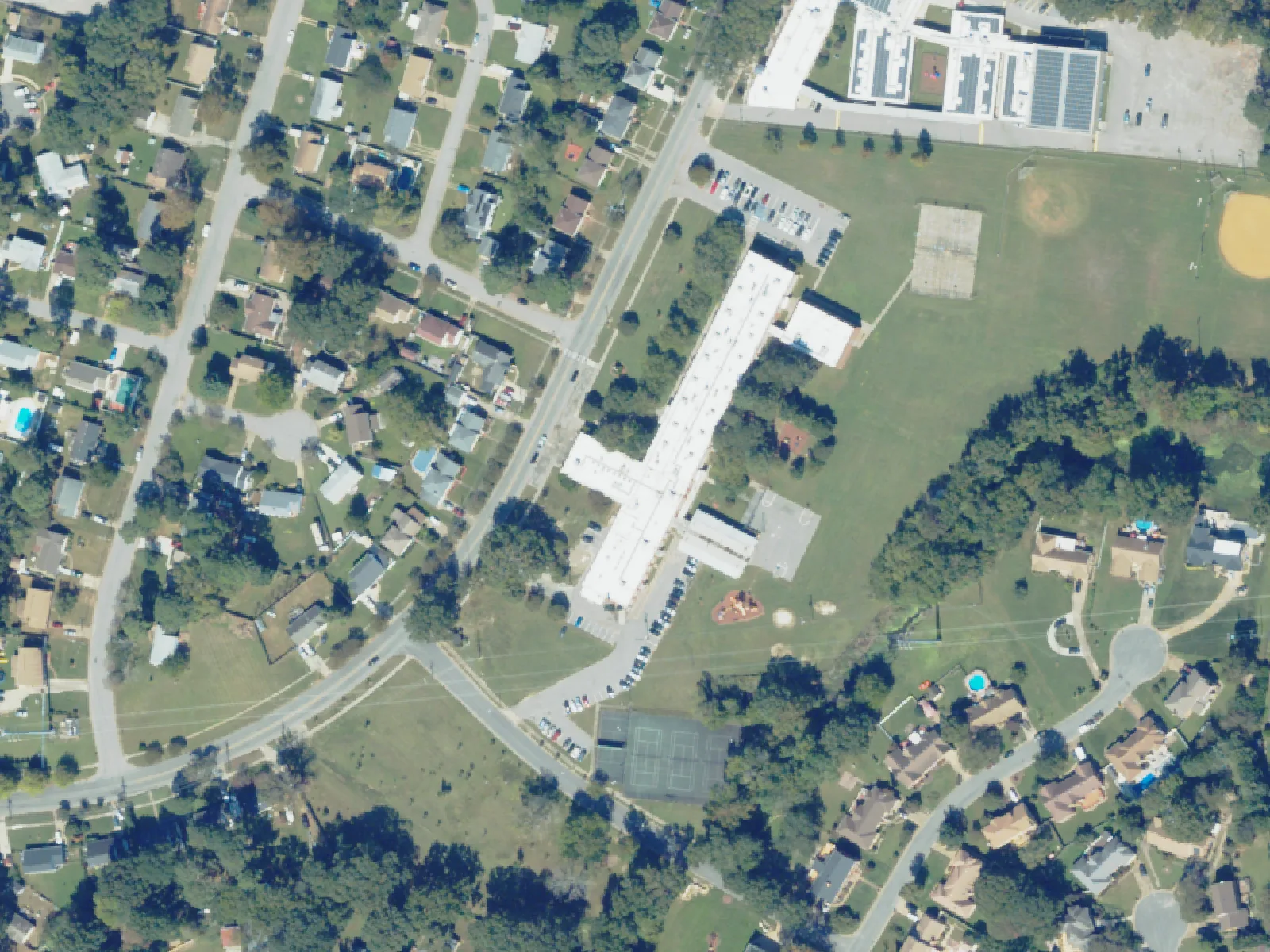Larrymore Elementary School and its grounds, center, from the air in October 2023.