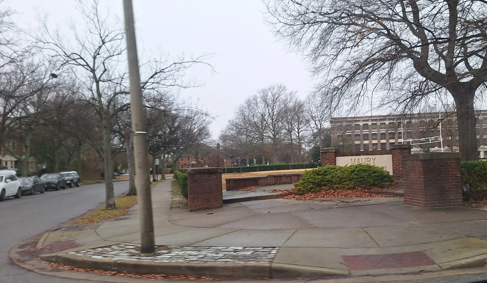 The Maury High School sign, with the school building behind it, in Norfolk.