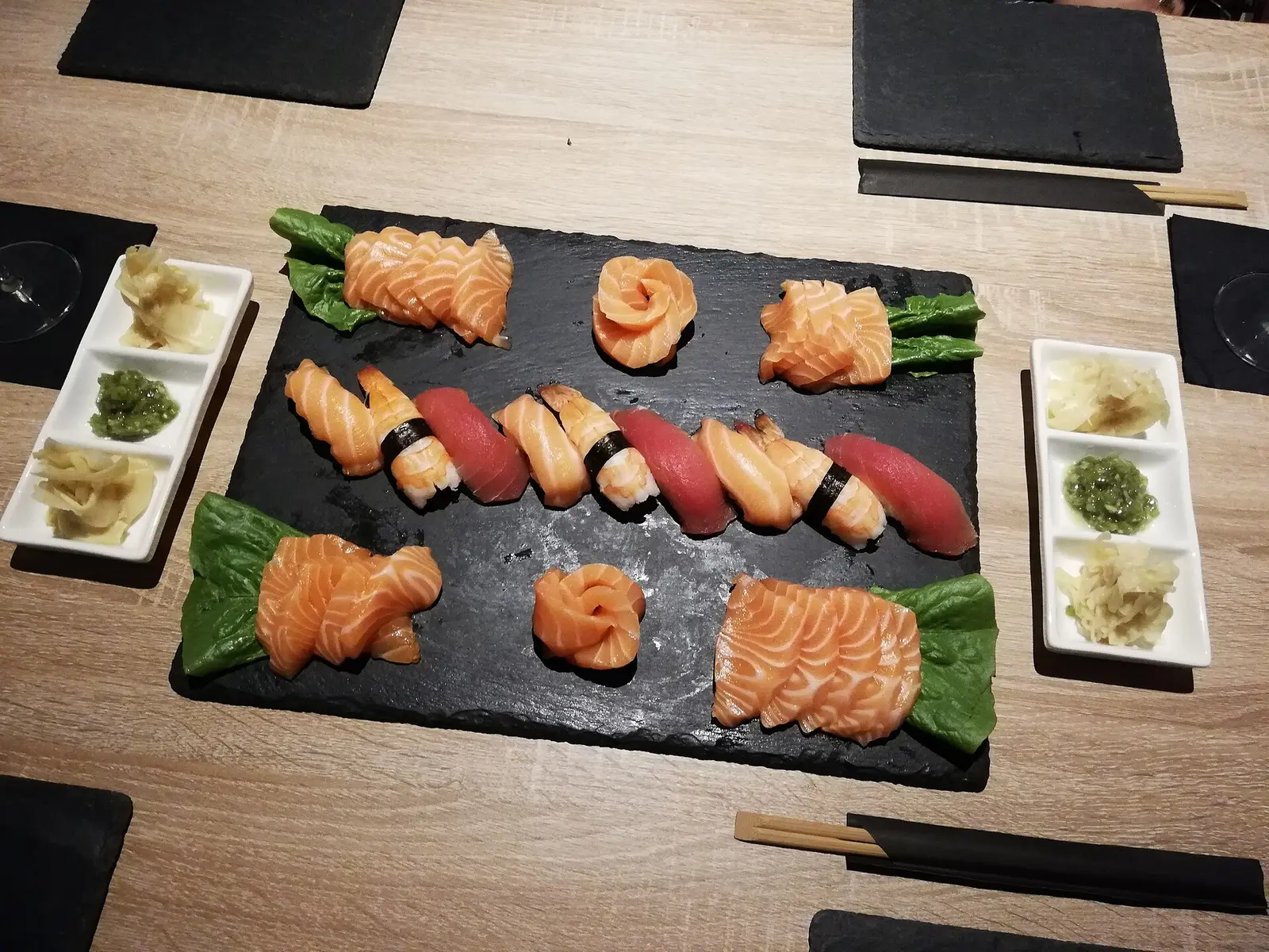 Salmon and tuna nigiri and sashimi on a slate platter. The photo was not taken at a Norfolk restaurant.