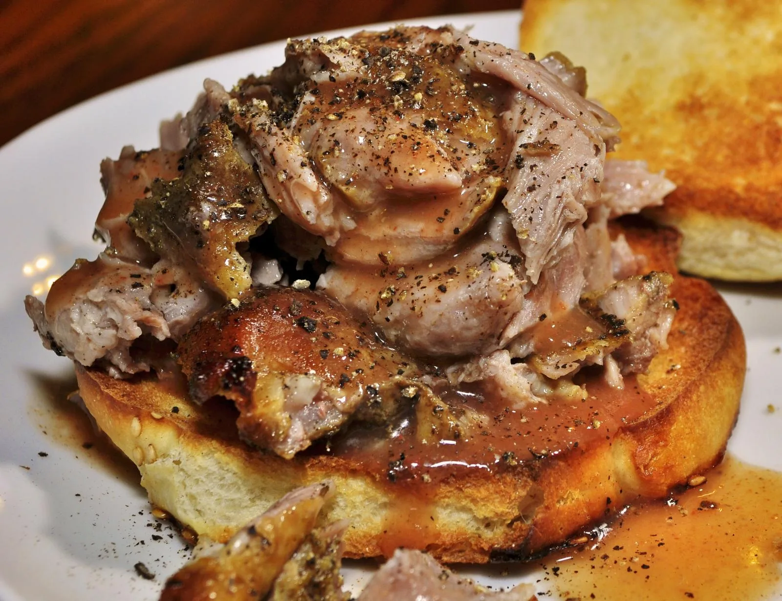 A pulled pork barbecue sandwich on a toasted bun. The photo was not taken at a Norfolk restaurant.