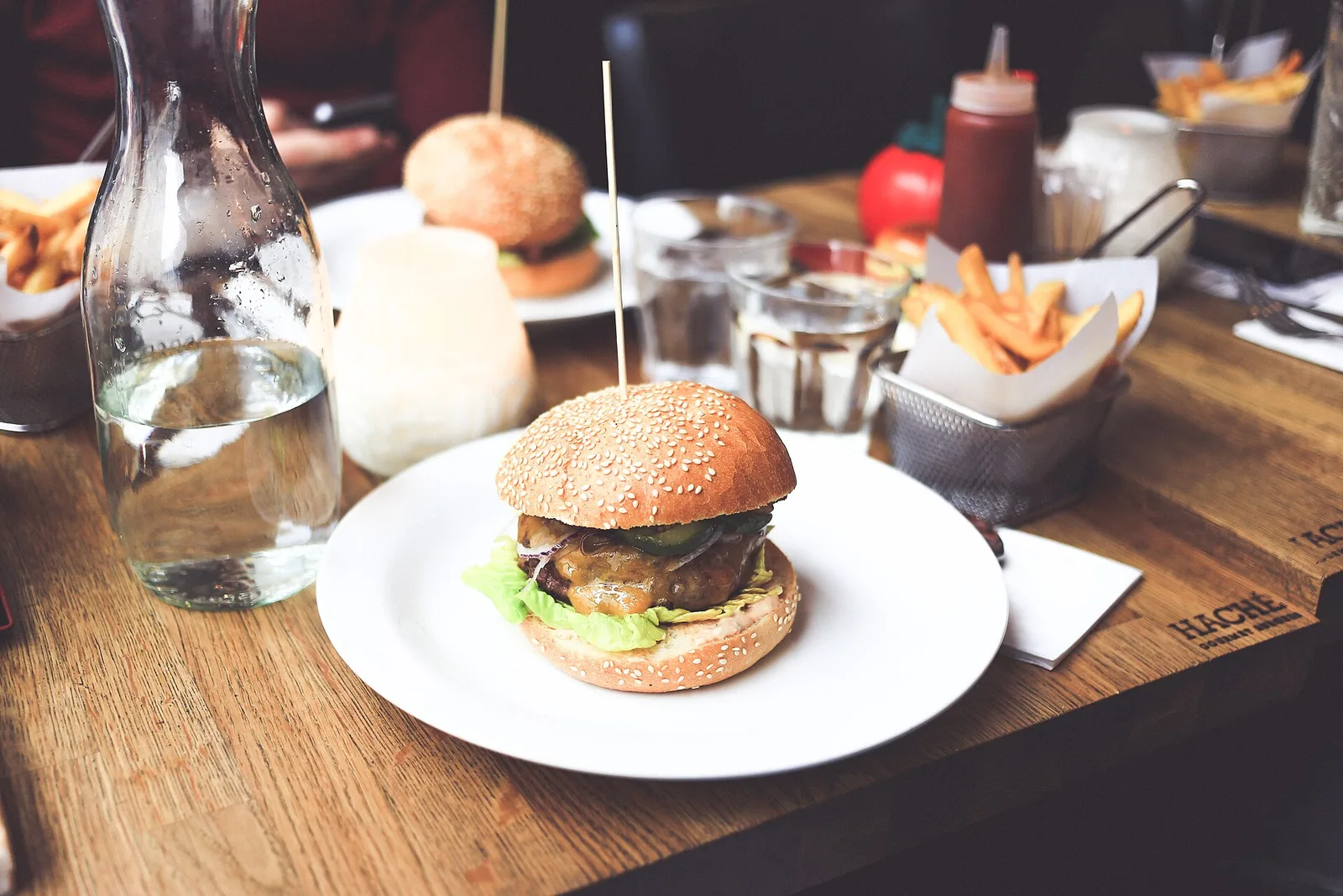 A cheeseburger with fries on a restaurant table. The photo was not taken at a Norfolk restaurant.